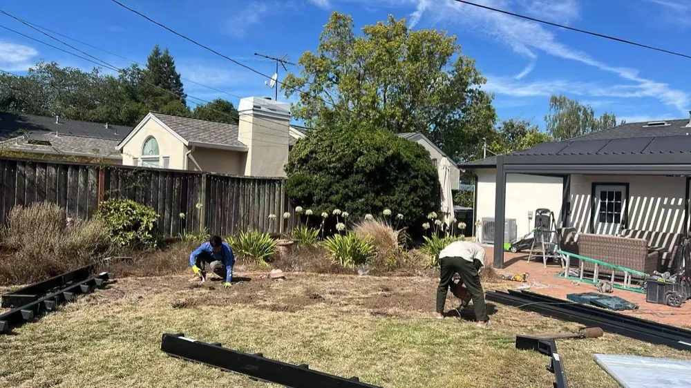 Crew levelling a California backyard and setting out the steel base for a MagicNest