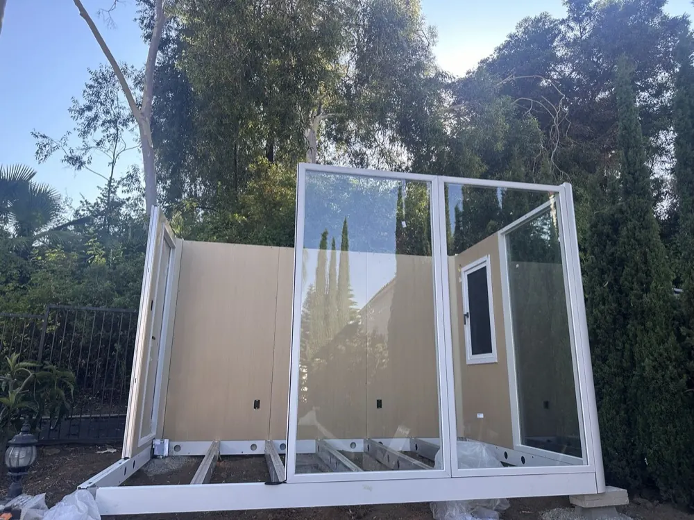 MagicNest wall panels and glass door frame going up on the steel base